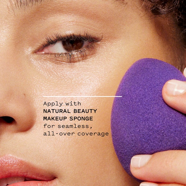 Model applying concealer tint with natural beauty makeup sponge